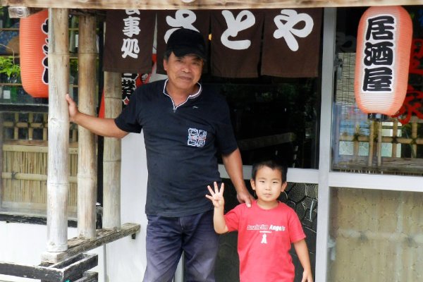 A photo of Maehama-san and his grandson in front of the inn's restaurant