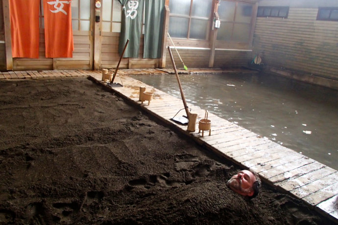 A photo of Kirk enjoying a hot-sand bath