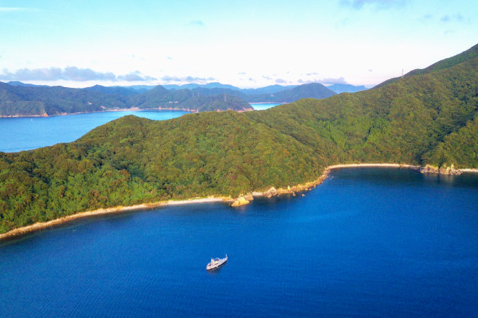 A drone photo showing Konpira Consulting's first client, M/V Buffalo Nickel, anchored off of Naru Island in the Goto Islands