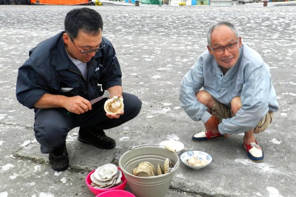 A photo of Sasa-san (right) with a member of the Hamaonishibetsu Fishing Co-op