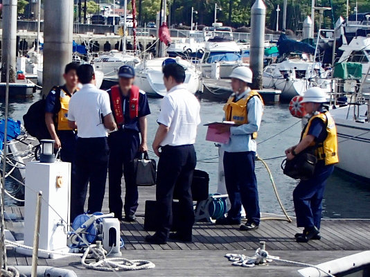 A photo of officials gathered in a fishing port